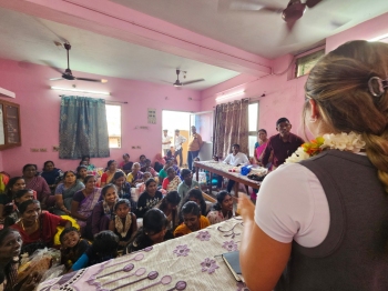 Mackinzie Reinert presents in front of schoolchildren in India